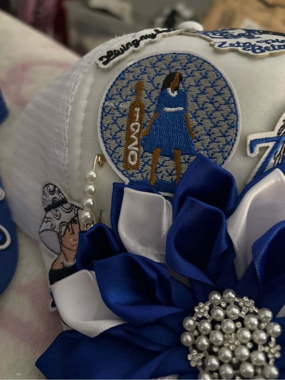 White Hat with Blue & White Flower Appliqué